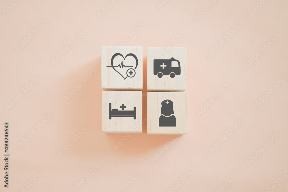 arranged wooden cube block with health and medical icon on sweet orange background arranged wooden cube block with health and medical icon on sweet orange background
