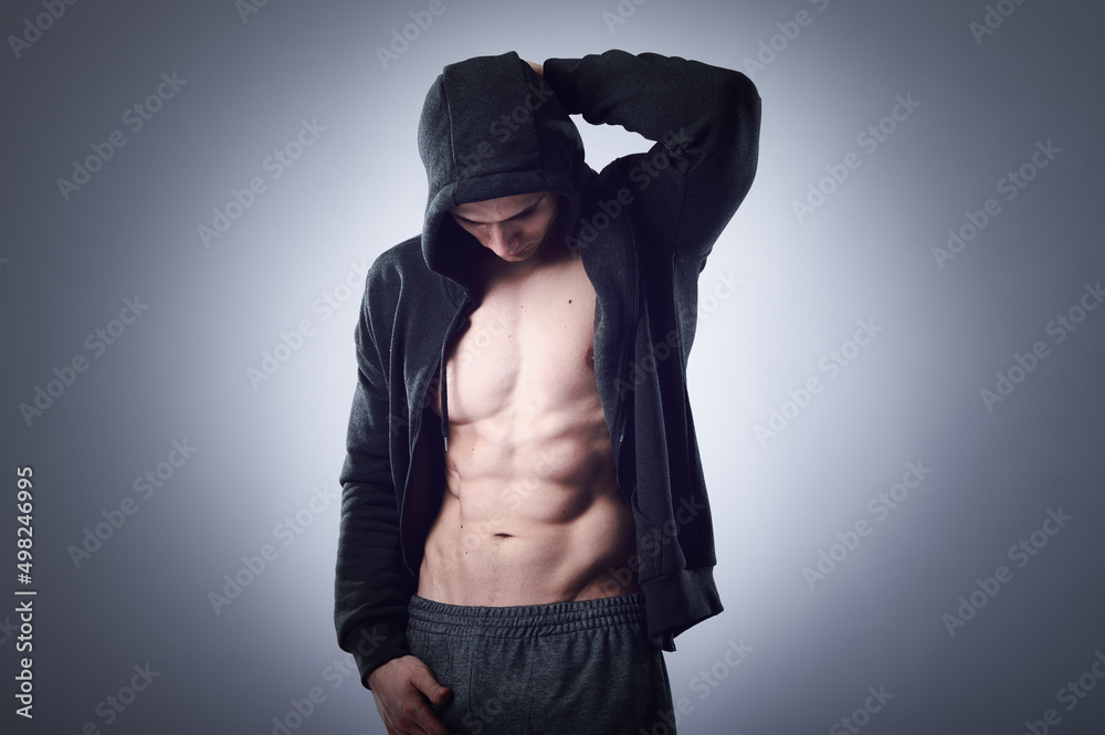 Workout fitness concept. Muscular sportsman with strong abs and body on gray background