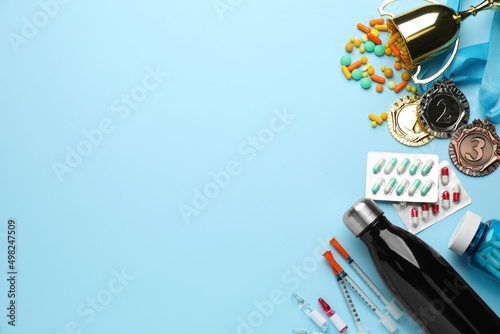 Flat lay composition with drugs on light blue background, space for text. Doping control