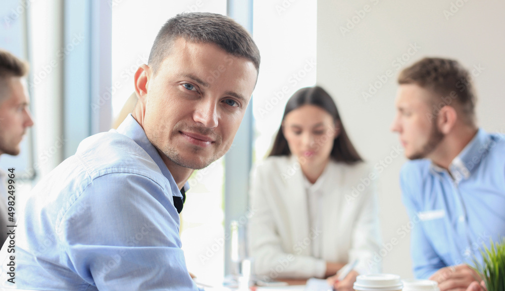 Businessman with colleagues in the background in office. Businessman with colleagues in the background in office.
