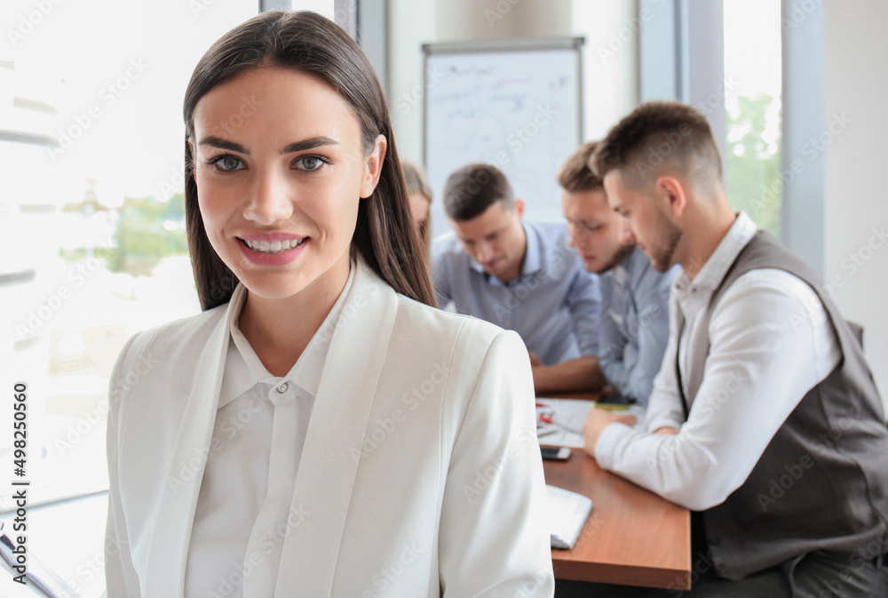 Face of beautiful woman on the background of business people Face of beautiful woman on the background of business people