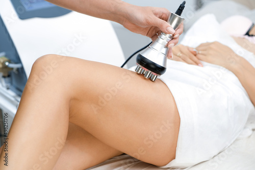 Rf lifting procedure on the legs, buttocks and back, hips of a woman in a beauty parlor. photo