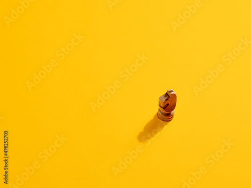 Knight or horse chess piece on yellow background