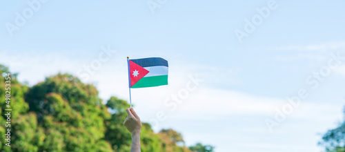 Fotografie, Tablou hand holding Jordan flag on nature background
