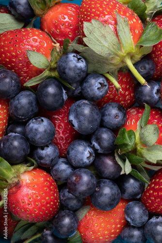 Full frame shot of fresh strawberries with blueberries  copy space