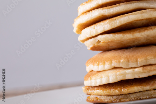 Close-up of pancakes stacked against gray background with copy space