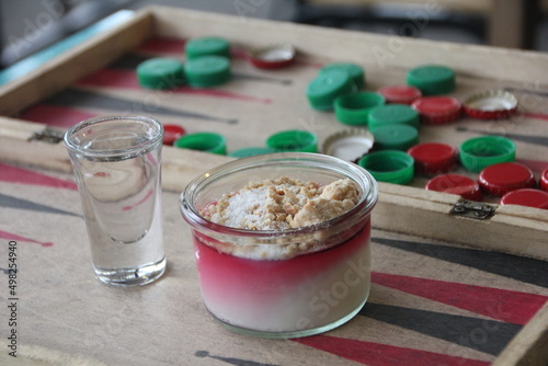 Malabi served with nuts and coconut shavings on a backgammon board 