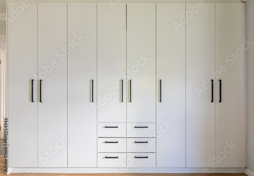 Konstfotografi Closed doors and drawers of white wardrobe at home, copy space