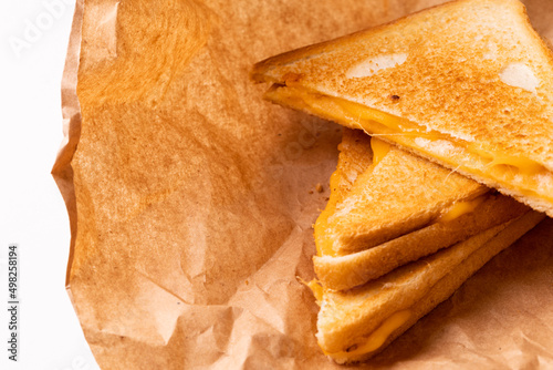 Close-up of fresh cheese toast sandwich on brown wax paper