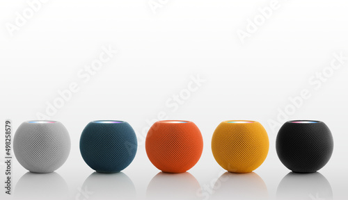 Set of round bluetooth speakers in different colors on a white background.