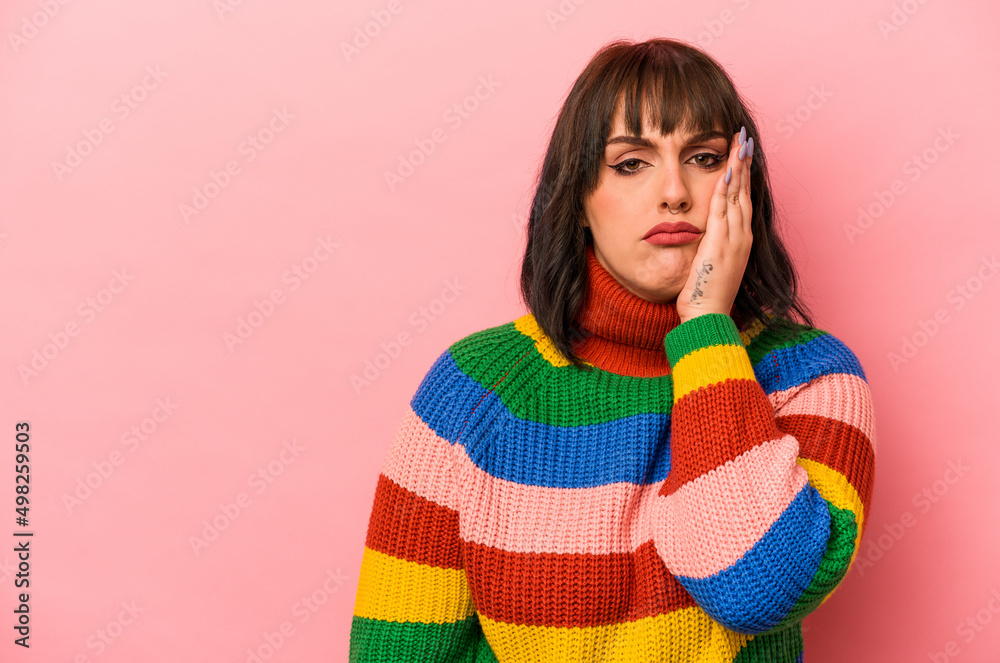 Young caucasian woman isolated on pink background who feels sad and pensive, looking at copy space. Young caucasian woman isolated on pink background who feels sad and pensive, looking at copy space.