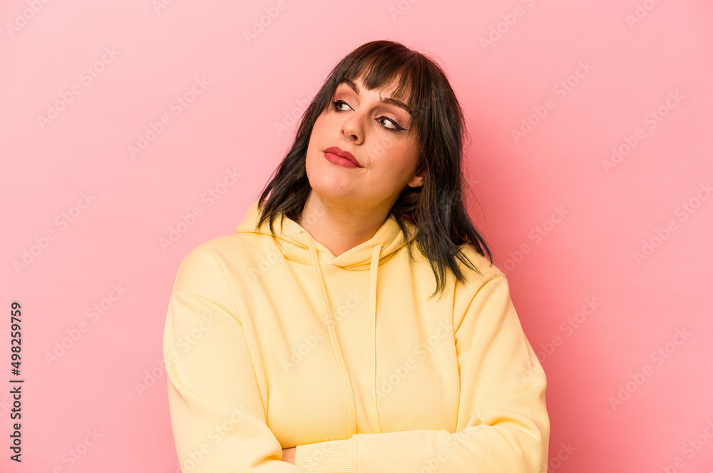 Fototapeta premium Young caucasian woman isolated on pink background dreaming of achieving goals and purposes
