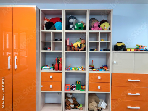 Children's rack with toys in a children's playroom or kindergarten.