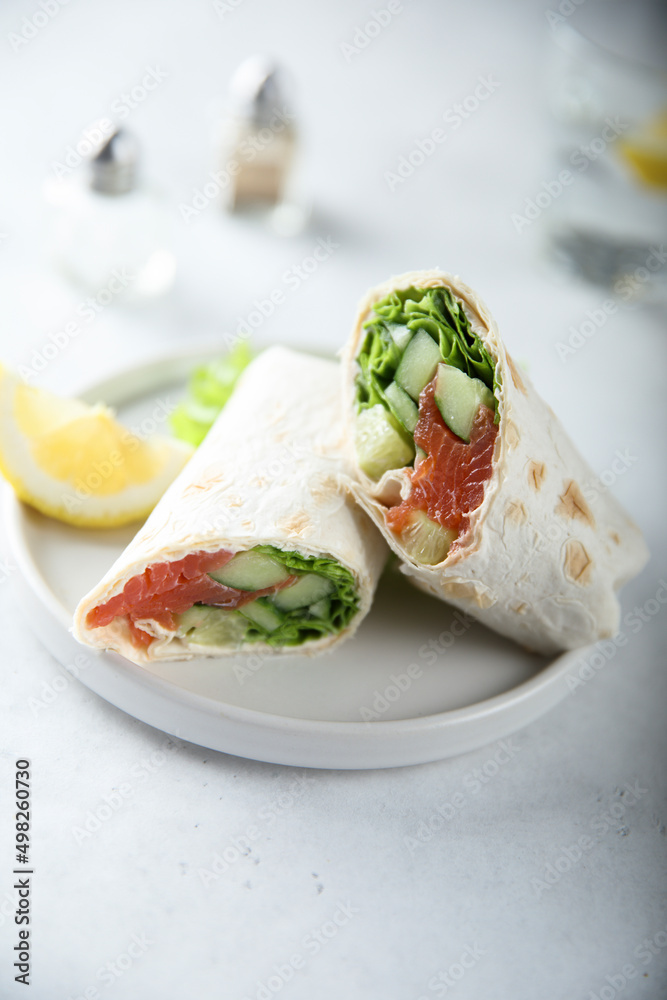 Healthy salmon wrap with fresh salad