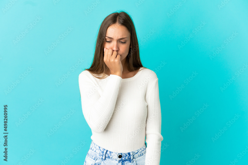 Young woman over isolated blue background having doubts Young woman over isolated blue background having doubts