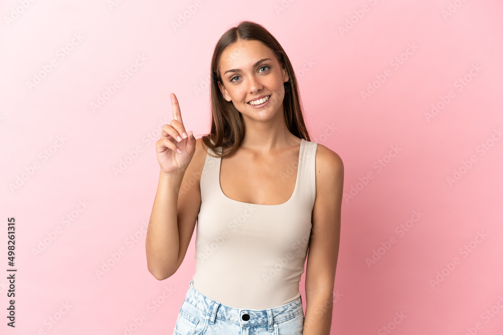 Young woman over isolated pink background pointing up a great idea Young woman over isolated pink background pointing up a great idea