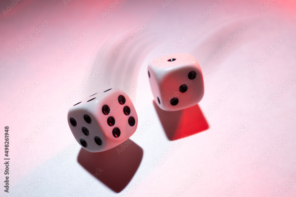 White Dice in Motion on a White Shadowy Background White Dice in Motion on a White Shadowy Background