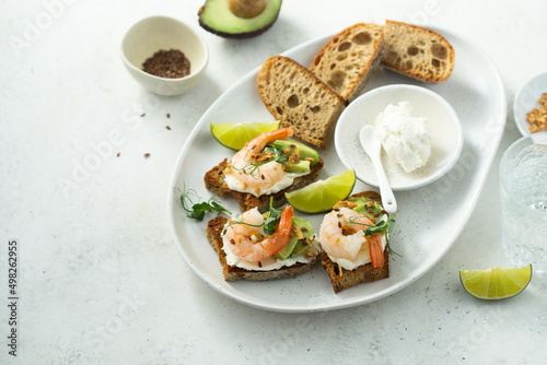 Roasted shrimps with cream cheese on toast