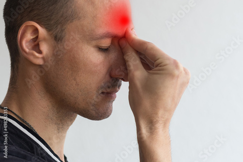 man with headache, head hurts, experiencing pain