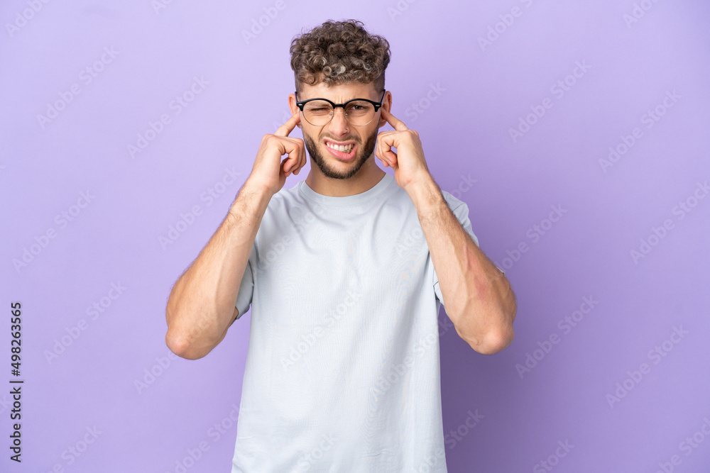 Delivery caucasian man isolated on purple background frustrated and covering ears Delivery caucasian man isolated on purple background frustrated and covering ears