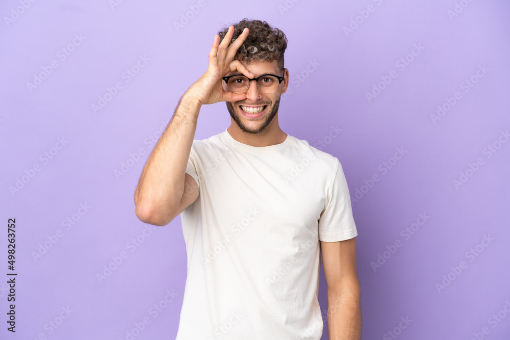 Delivery caucasian man isolated on purple background showing ok sign with fingers Delivery caucasian man isolated on purple background showing ok sign with fingers