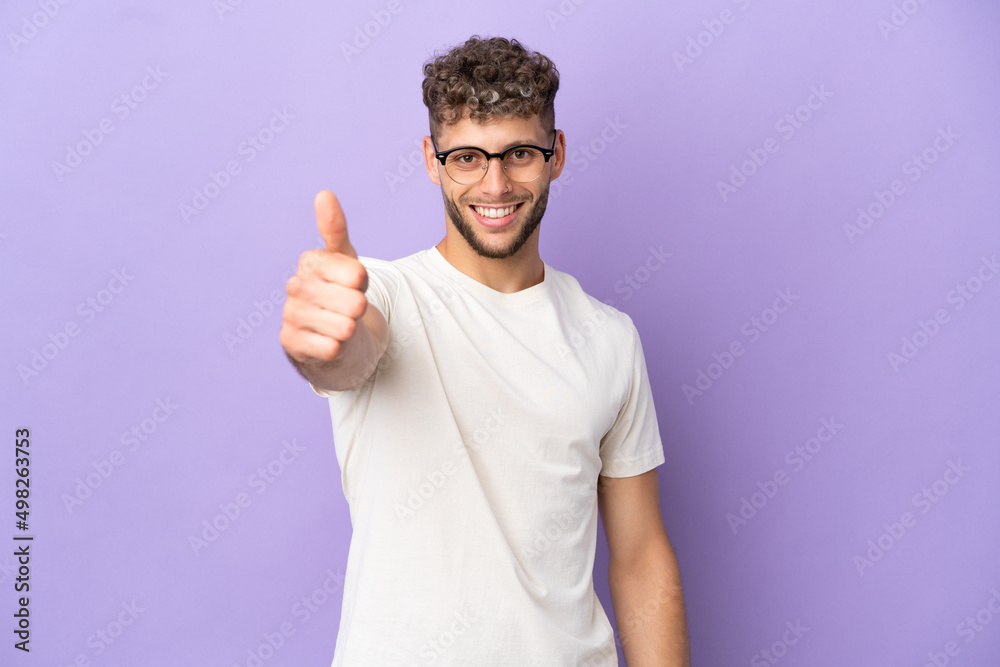 Delivery caucasian man isolated on purple background with thumbs up because something good has happened Delivery caucasian man isolated on purple background with thumbs up because something good has happened