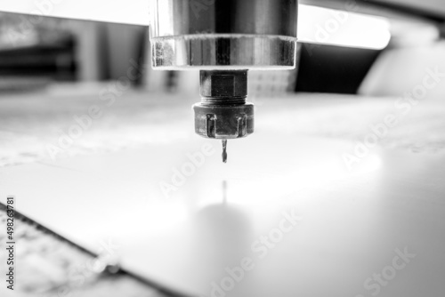 CNC drilling machine is working with metal plate. Close-up