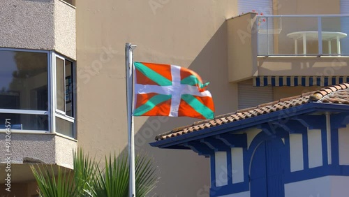 Ikurrina flag, a Basque symbol and the official flag of the Basque Country Autonomous Community of Spain and France, waving in front of a house in Arcachon photo
