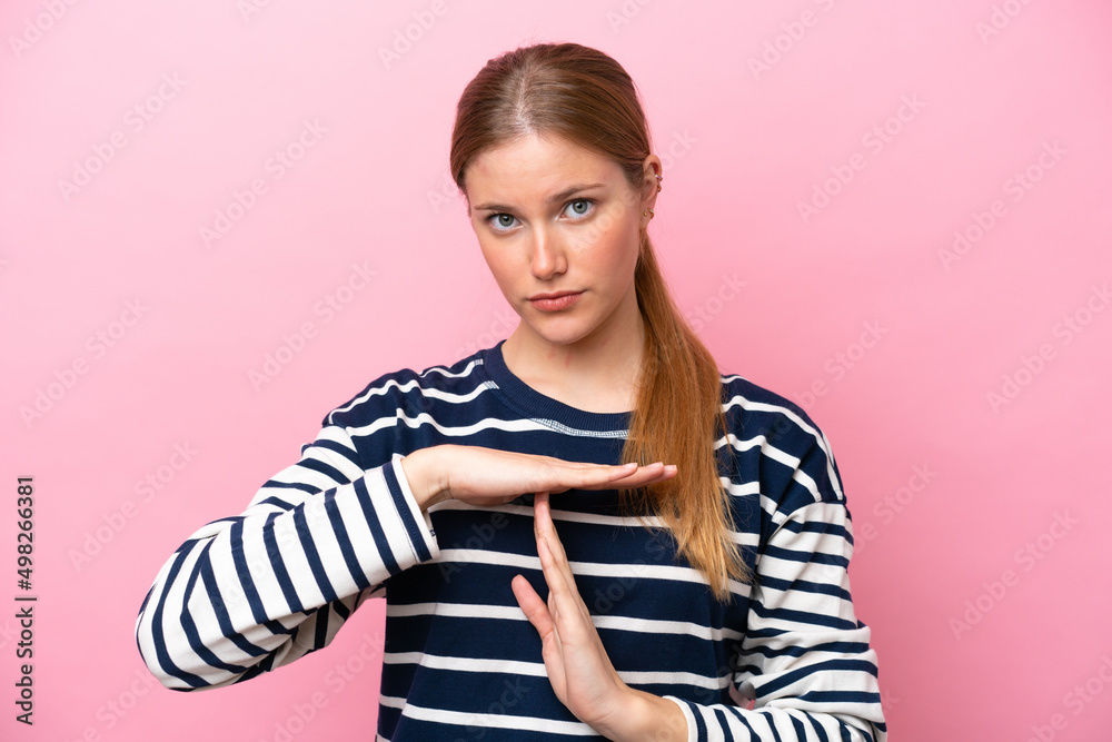 Young caucasian woman isolated on pink background making time out gesture Young caucasian woman isolated on pink background making time out gesture