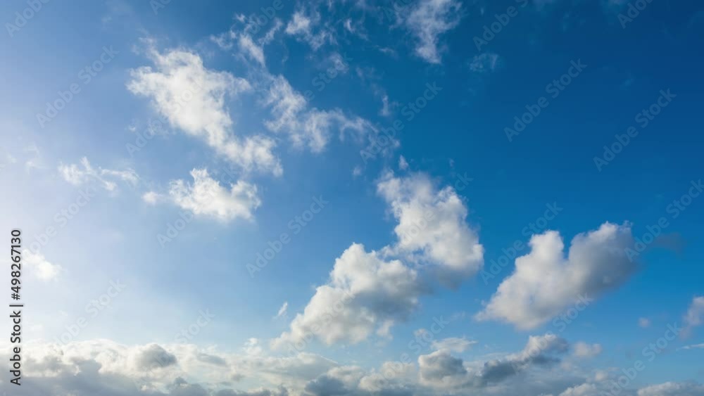 Fast moving white clouds on the blue sky. 4K sky cloud time lapse.