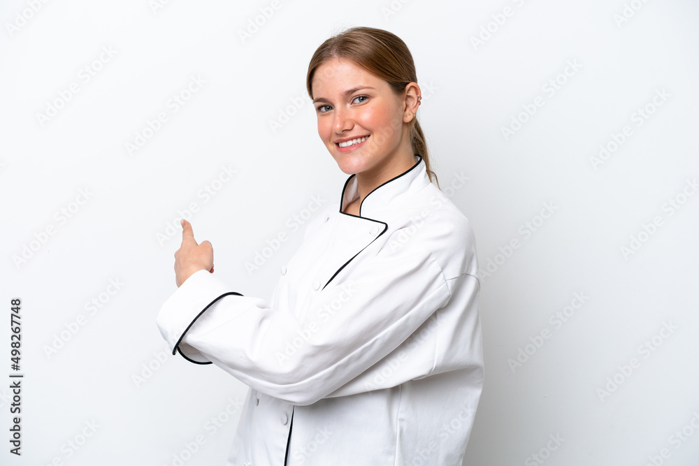Young chef woman isolated on white background pointing back Young chef woman isolated on white background pointing back