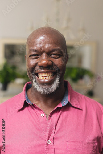 Close-up portrait of african american senior man smiling at home