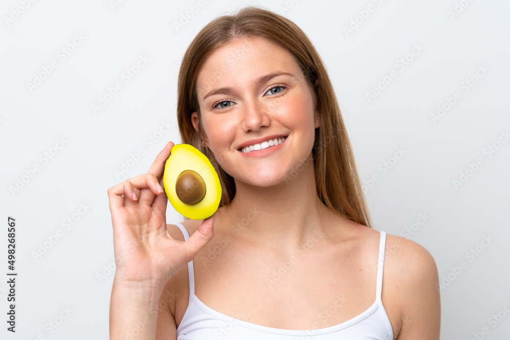 Young caucasian woman isolated on white background holding an avocado while smiling. Close up portrait Young caucasian woman isolated on white background holding an avocado while smiling. Close up portrait