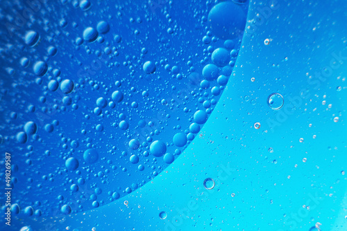 abstract light blue background with oil circles . bubbles of water close up .