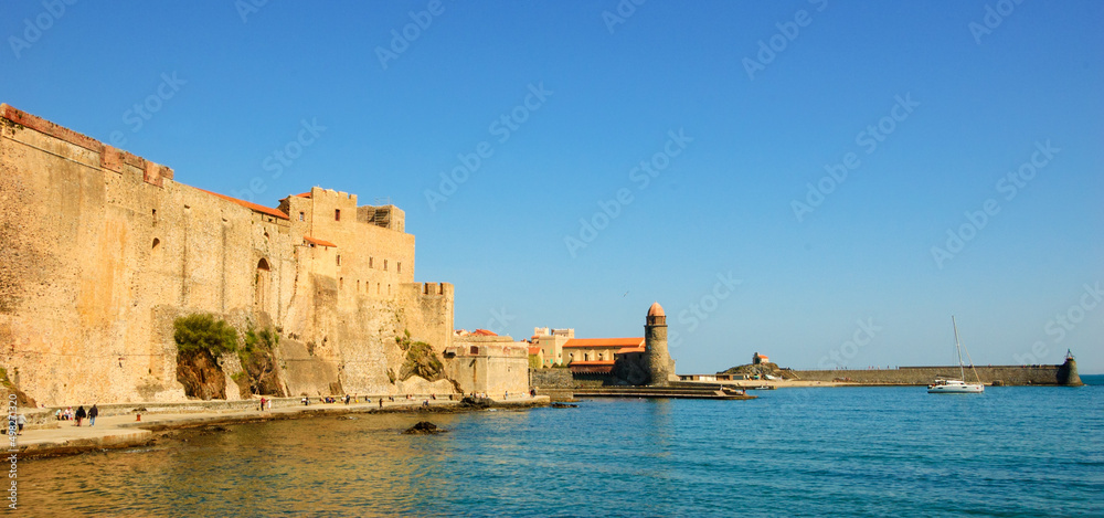 Collioure, South of France. Seaside promenade under medieval walls. Church and lighthouse at background. Travel banner