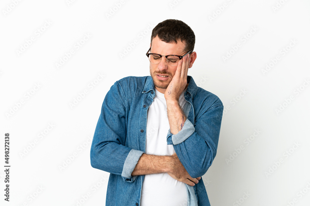 Brazilian man over isolated white background with headache Brazilian man over isolated white background with headache
