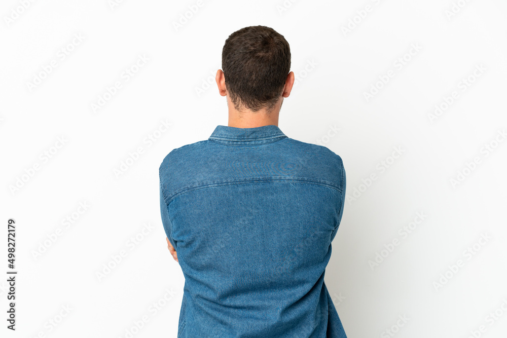Brazilian man over isolated white background in back position Brazilian man over isolated white background in back position