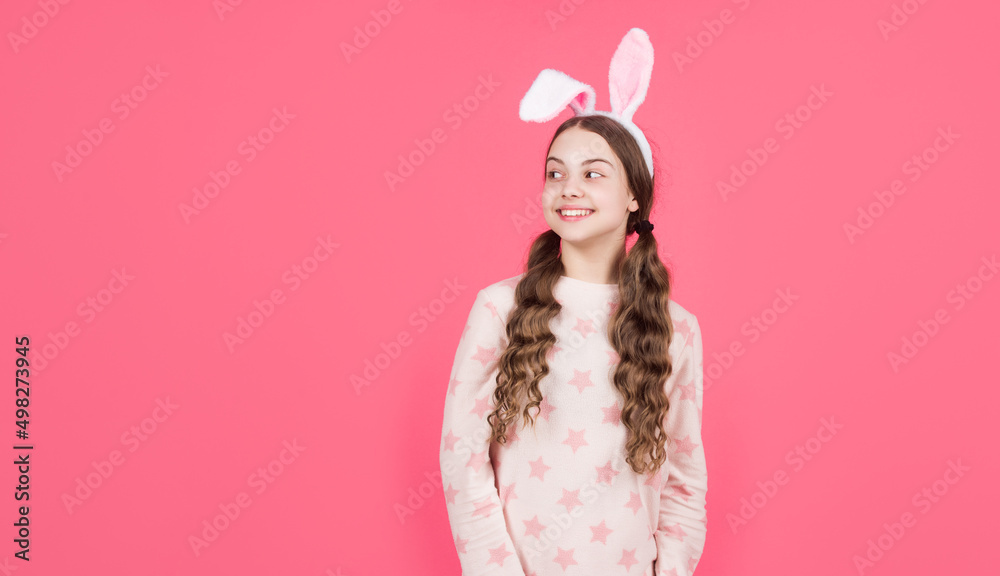 happy easter teen girl in bunny rabbit ears and pajamas, copy space, easter