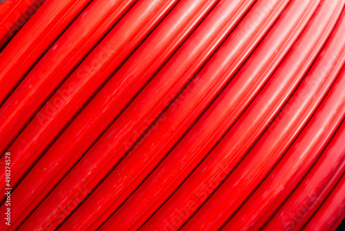 Red wire cable in reels close up background