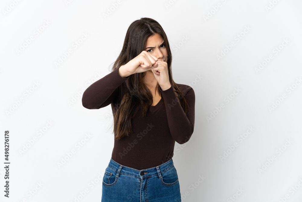 Teenager Brazilian girl isolated on white background with fighting gesture Teenager Brazilian girl isolated on white background with fighting gesture