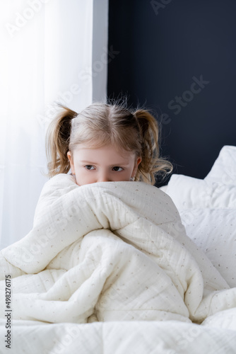 Wallpaper Mural scared girl sitting on bed and obscuring face with white blanket. Torontodigital.ca