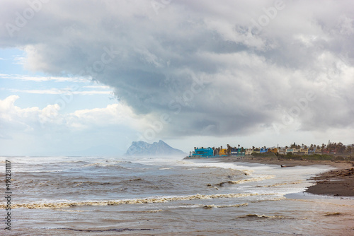 Rock of Gibraltar in the distance with a stormy spanish coast