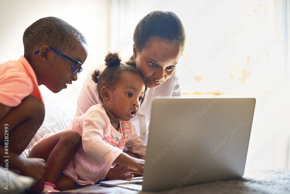 She wants to touch ALL the buttons. Cropped shot of an affectionate young family using a laptop together at home. She wants to touch ALL the buttons. Cropped shot of an affectionate young family using a laptop together at home.