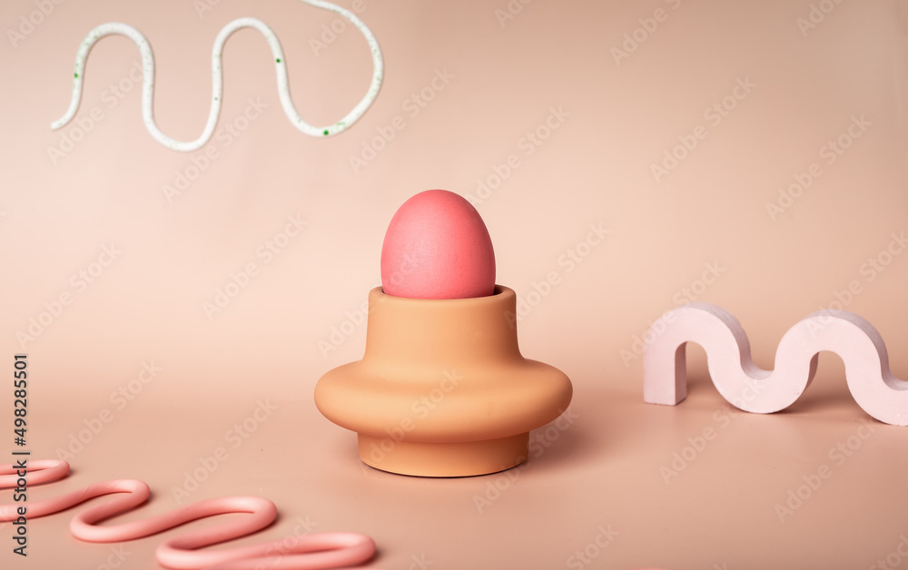 Pink Easter egg in server and wave-shaped geometric figures on pastel background. Symbol of religious holiday in modern and minimalistic style. High quality photo Pink Easter egg in server and wave-shaped geometric figures on pastel background. Symbol of religious holiday in modern and minimalistic style. High quality photo