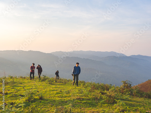 Trekking group enjoying on mountain trail in tropical forest at Tak Province, Thailand.