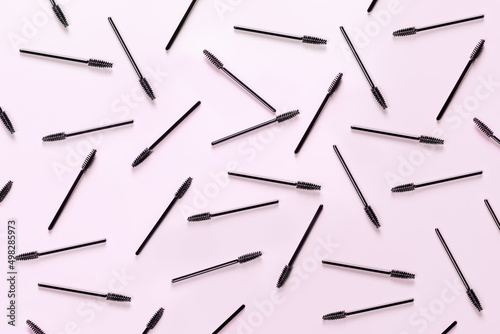 Set of brushes for eyelashes and eyebrows on pink background. Correction and care. Cooling and laying. Womens cosmetics.