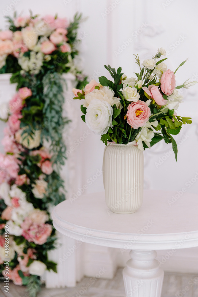 Modern vase with flowers in the children's room in white and pink tones on the background of the fireplace, modern interior design Modern vase with flowers in the children's room in white and pink tones on the background of the fireplace, modern interior design