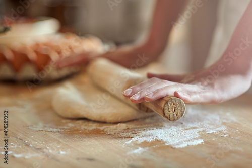 Fotografija Get rolling. Cropped shot of a set of hands rolling out dough.