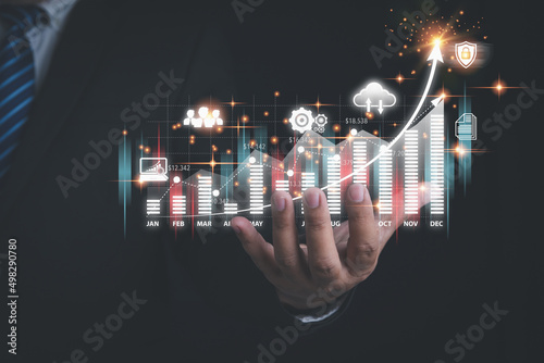 Hand of businessman holding pointing virtual screen on graph business with copy space. Investment stock market traded graph financial for-profit corporate in the future. Funds, and digital assets.