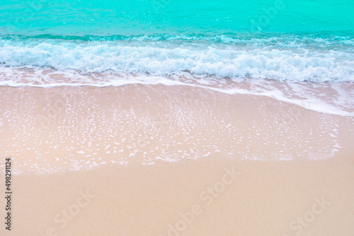 waves of the blue sea, turquoise sea waves breaking on the sandy coastline. golden beach meeting deep blue ocean water and foamy waves.